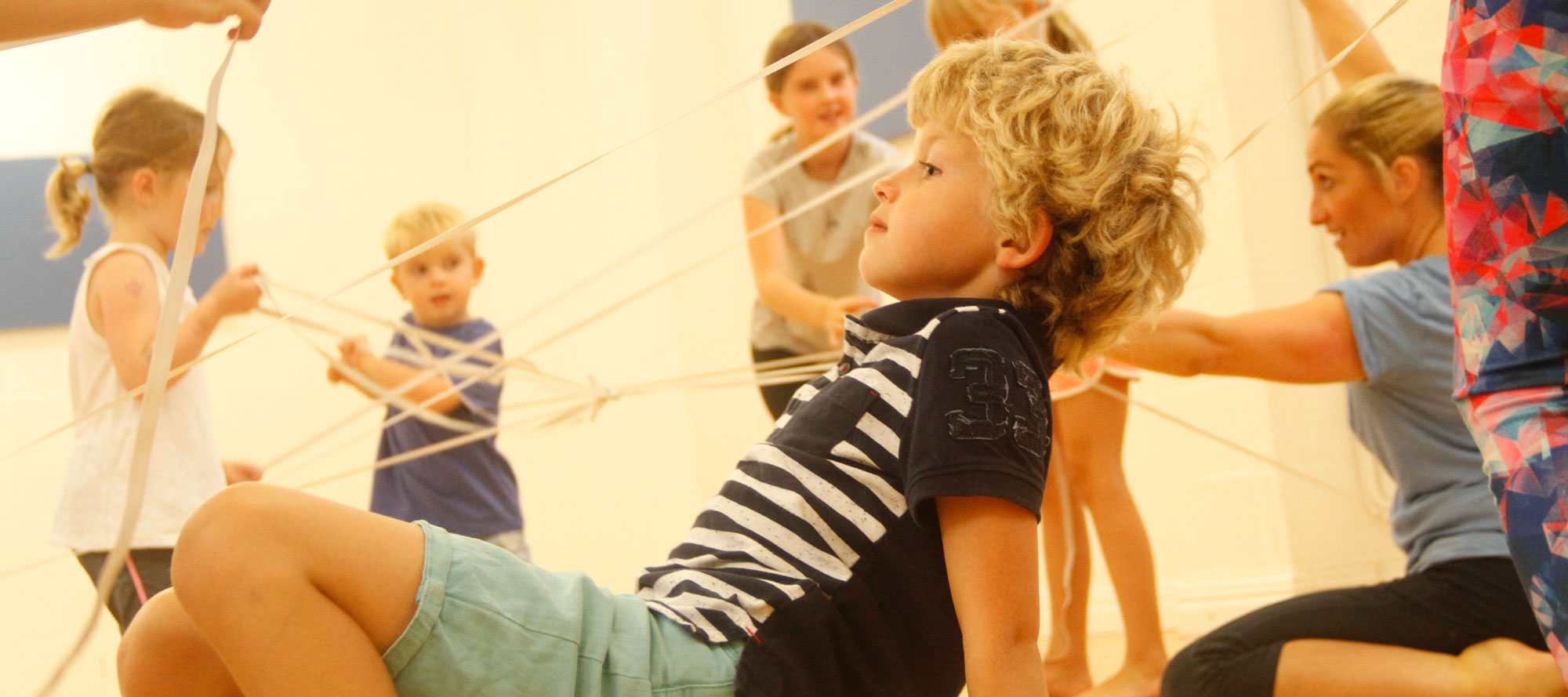 Year 5 pupils creating a web of movement with ribbon